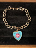 Vintage gold tone charm bracelet with guilloché heart 5 inches